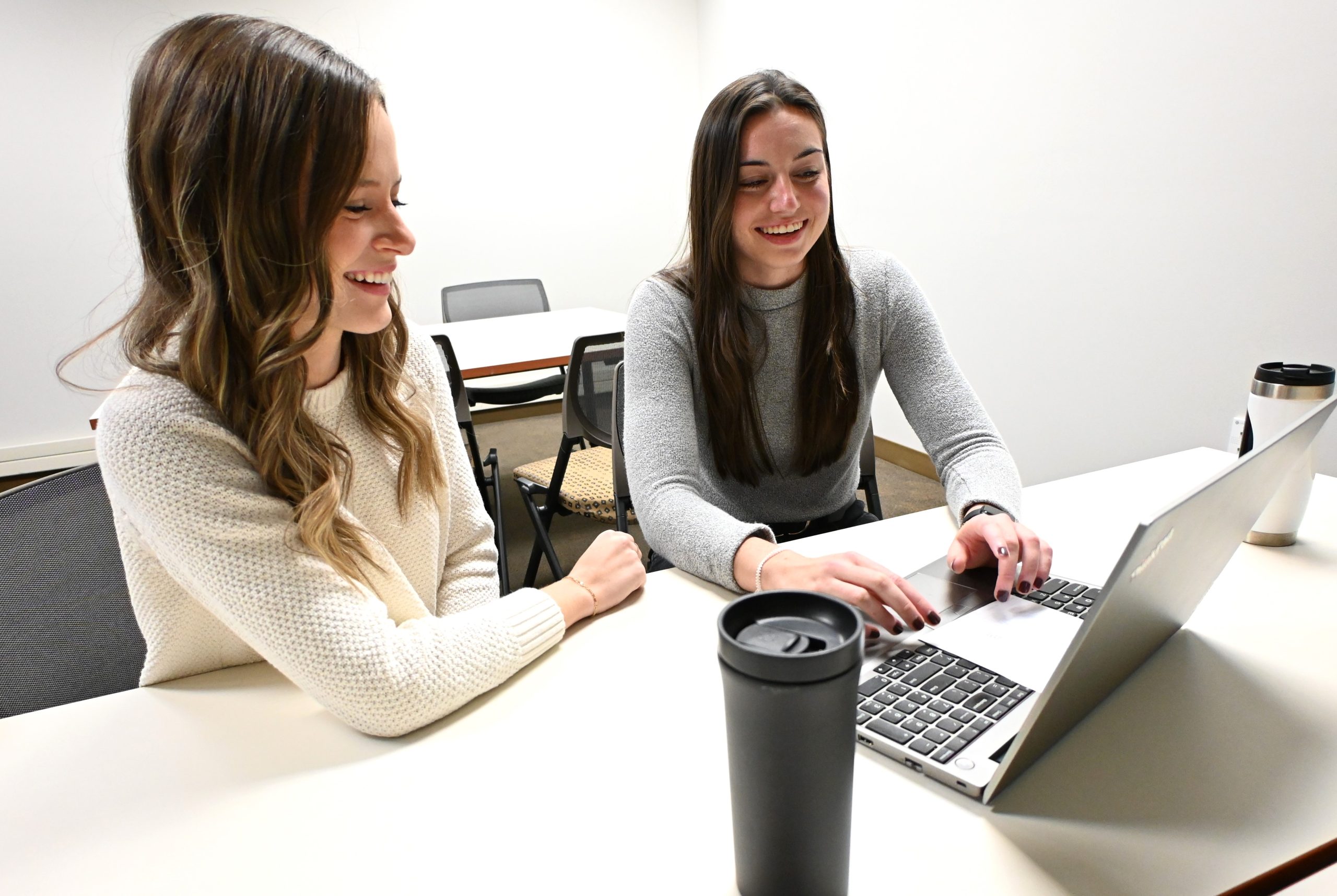Photo of two women working together in an office setting